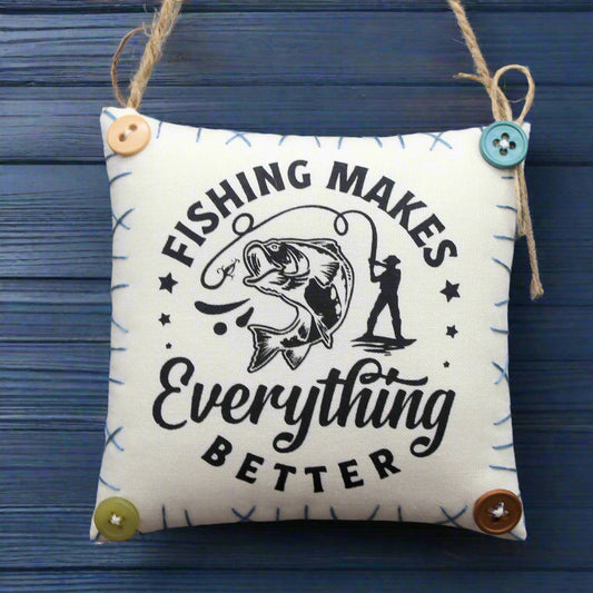 Fabric square with 'Fishing Makes Everything Better' text and graphics on a blue wooden background