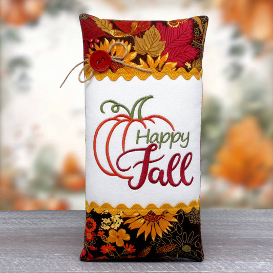 Tall slender pillow tuck or bowl filler features a center panel embroidered with 'happy fall.'  The center panel is trimmed with rick rack and colorful fall fabric.