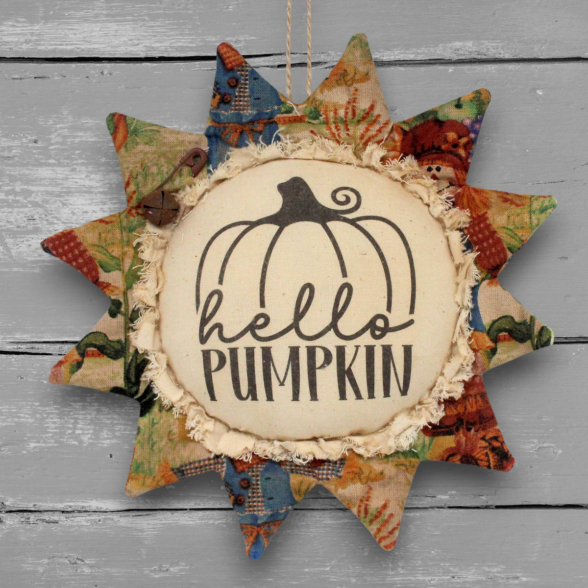 Handmade primitive fabric sunflower ornament with a printed center that reads "hello pumpkin"