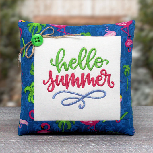 Small pillow tuck or bowl filler embroidered with 'hello summer' and trimmed with a fabric with a flamingo design.