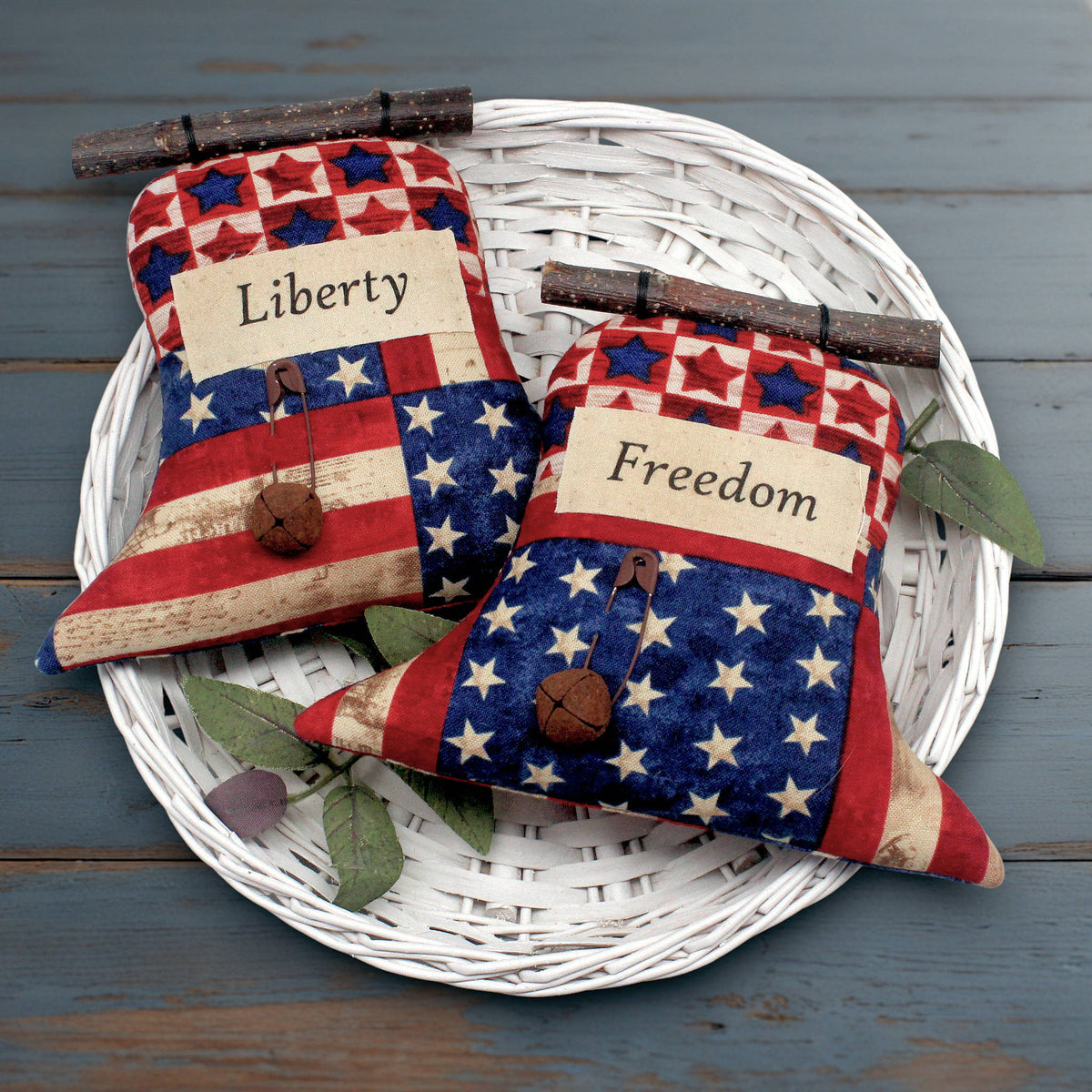 Set of two primitive fabric Liberty Bells sewn from Americana print fabrics.  They have rusty bells and safety pins 