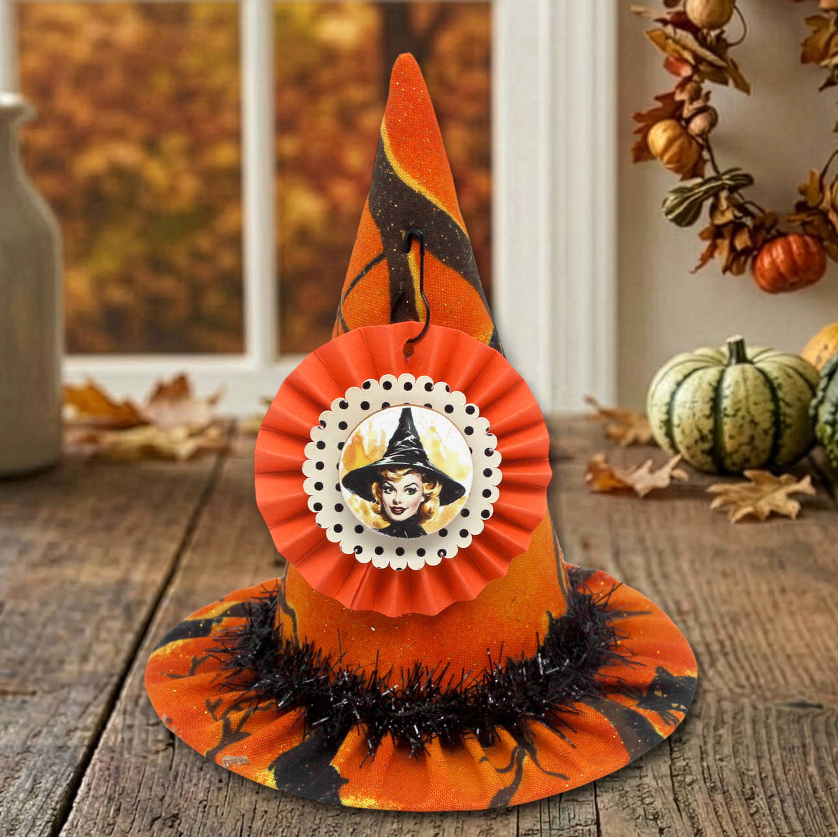 Miniature witch hat in orange print Halloween-themed fabric with a retro cardstock tag