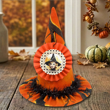 Miniature witch hat in orange print Halloween-themed fabric with a retro cardstock tag