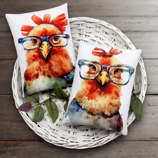 Two pillows with a chicken design wearing glasses on a white basket.