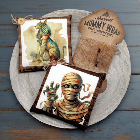 Decorative pillows with Egyptian-themed designs on a wooden surface