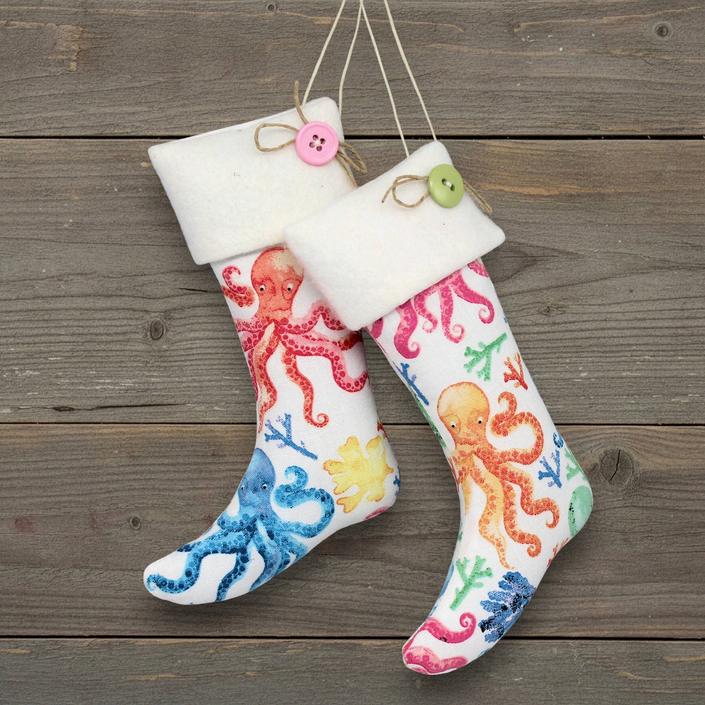 Colorful handmade octopus-patterned Christmas stocking ornaments with decorative buttons on a wooden surface