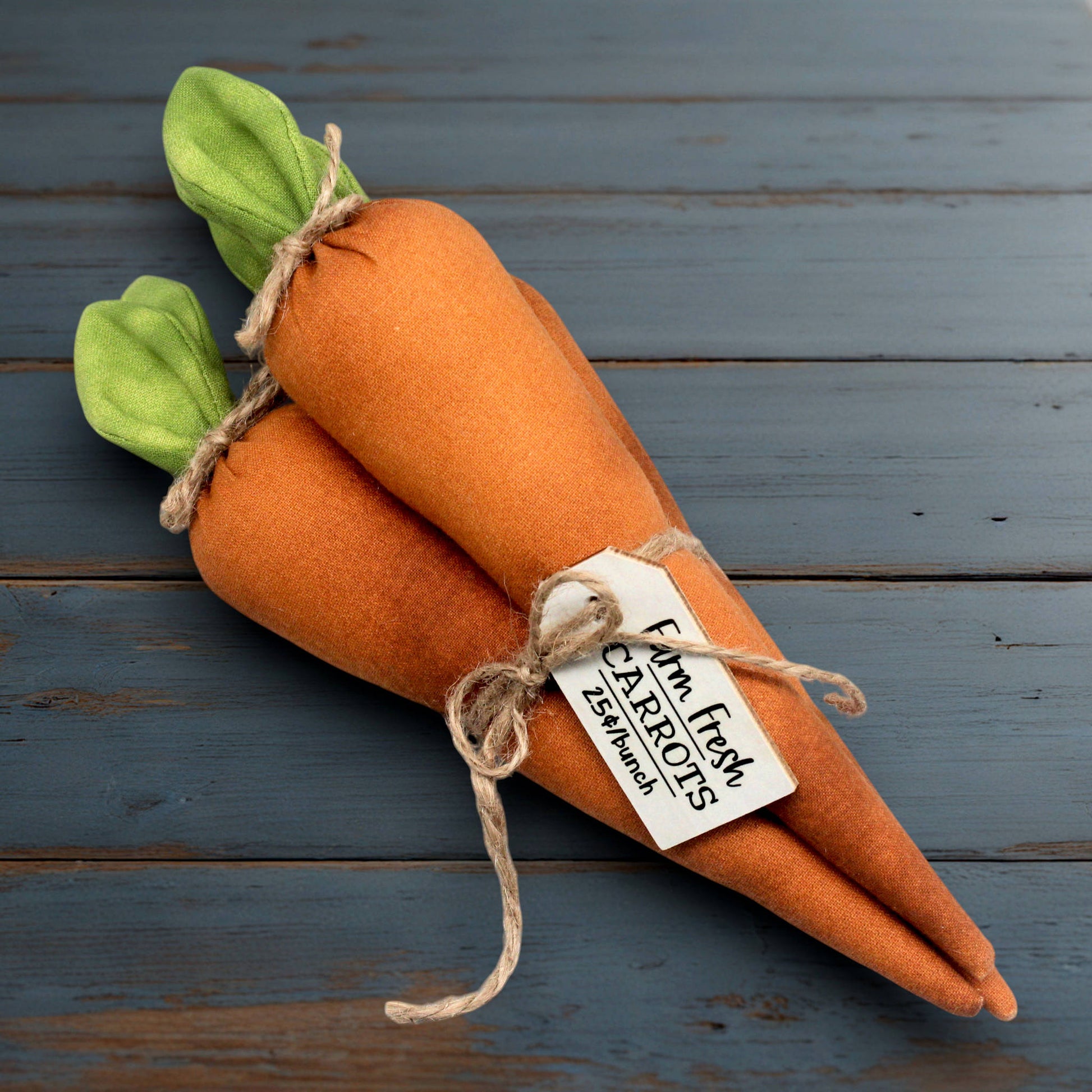 Bundle of fabric carrots tied up with jute twine and a wooden tag