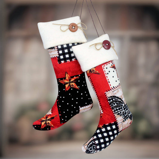 Two decorative Christmas stockings hanging side by side against a blurred outdoor background. The stockings feature a patchwork design with red, black, white, and brown fabrics, including star and gingham patterns, with white fleece cuffs and wooden buttons.