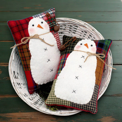 Set of two mini pillow bowl fillers with homespun patchwork backgrounds.  Each has a snowman stitched to it with a jute twine bow and a rusty bell attached by a safety pin