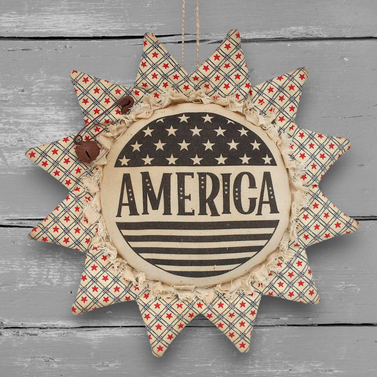 Primitive patriotic handmade fabric sunflower ornament with a printed center that reads "America" along with stars and stripes