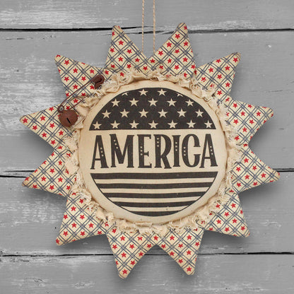 Primitive patriotic handmade fabric sunflower ornament with a printed center that reads "America" along with stars and stripes