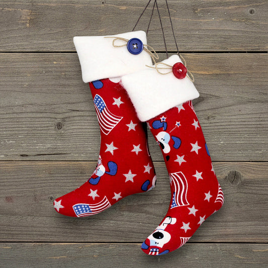 Pair of Christmas stocking ornaments with patriotic dogs, American flags and silver stars on a red fabric background
