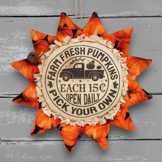 Primitive handmade fabric sunflower ornament or bowl filler with a printed center that advertises for a fresh pumpkin farm.