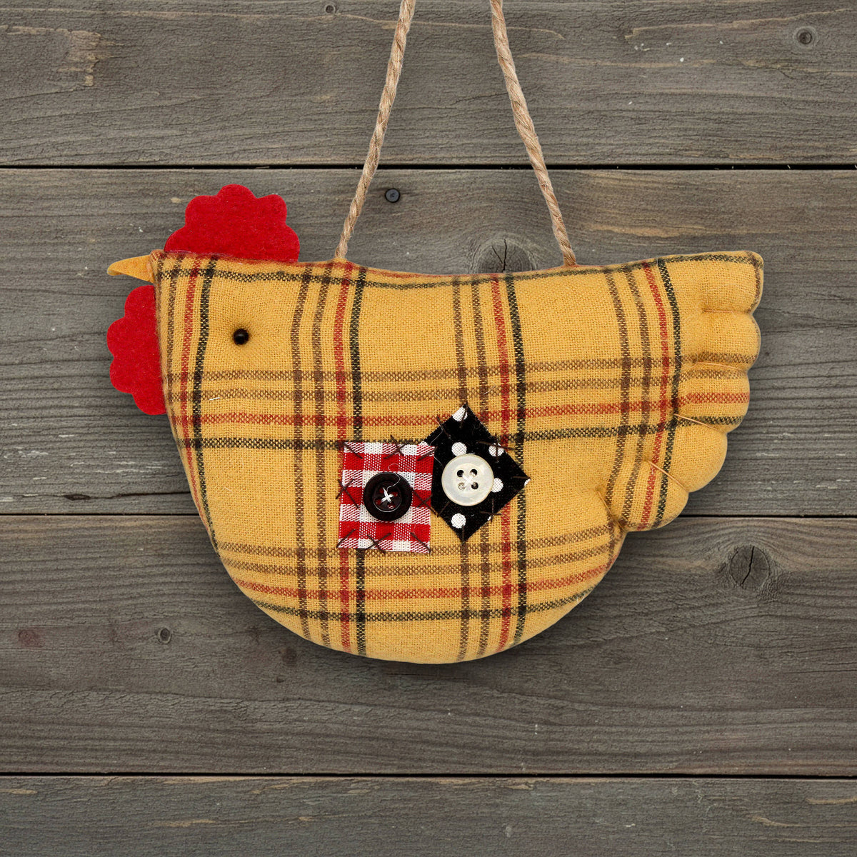 Plaid chicken ornament with a button on a wooden background