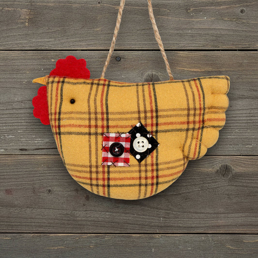 Plaid chicken ornament with a button on a wooden background