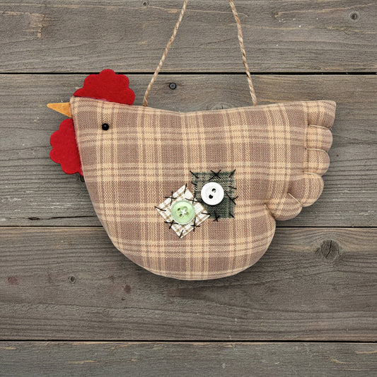 Plaid chicken-shaped ornament with a red comb on a wooden background