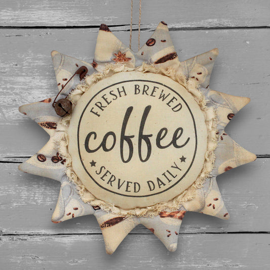 Primitive handmade fabric sunflower ornament with a printed center that advertises for freshly brewed coffee daily.
