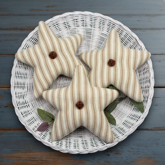Set of three tan and eggshell homespun star bowl fillers with rusty bells