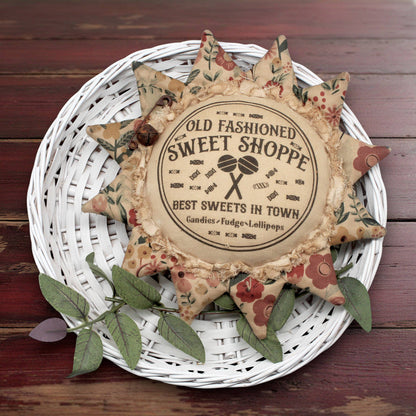 Primitive sunflower ornament with an advertisement for an old fashioned sweets shop
