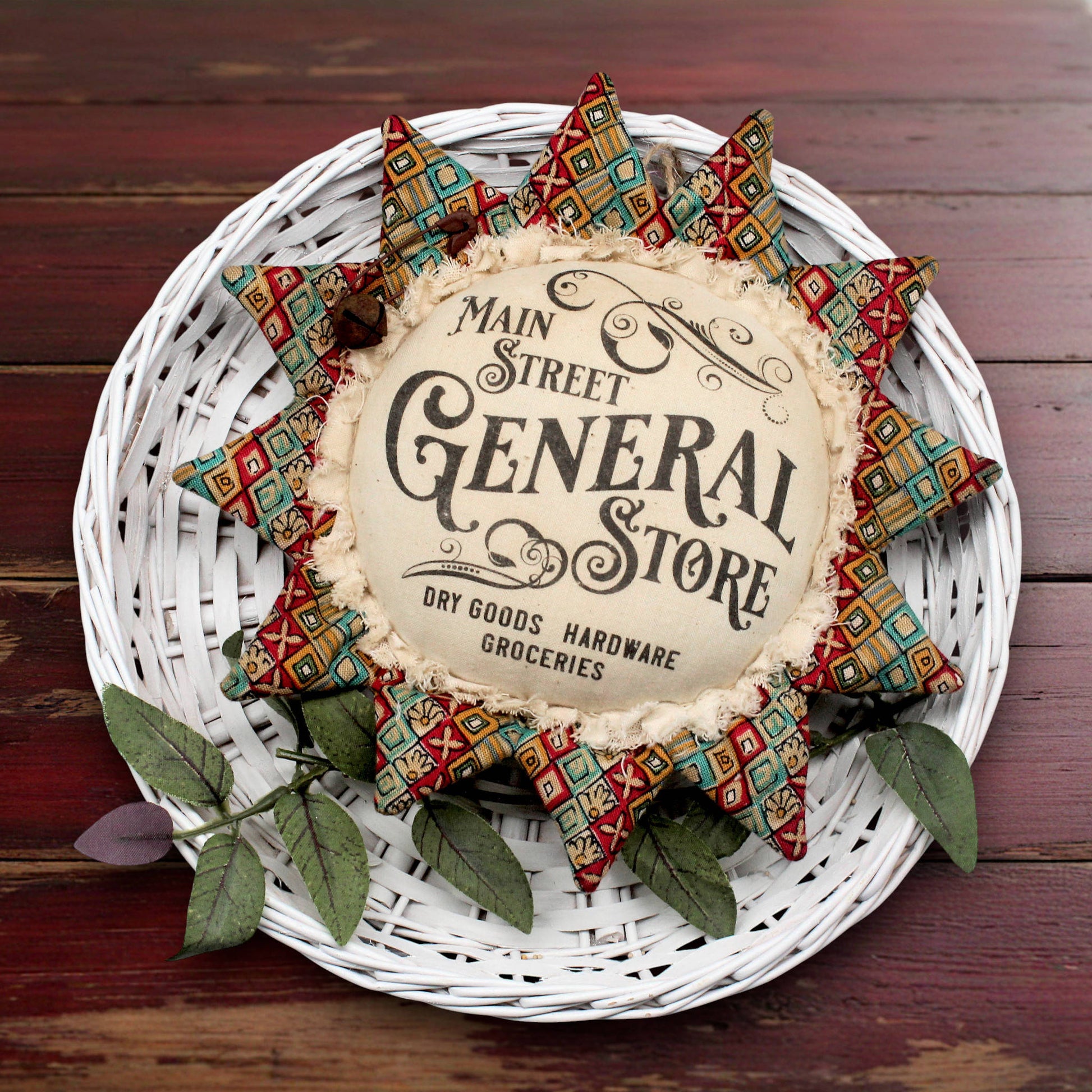 Primitive fabric sunflower ornament with an advertisement for the main street general store