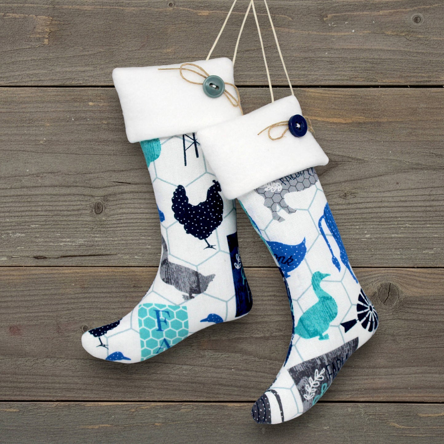 Pair of handmade country primitive Christmas stocking ornaments with a blue animal print design