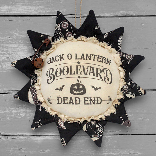 Primitive handmade fabric sunflower ornament or bowl filler with a printed center that reads "Jack O Lantern Boolevard - Dead End" for Halloween decorating
