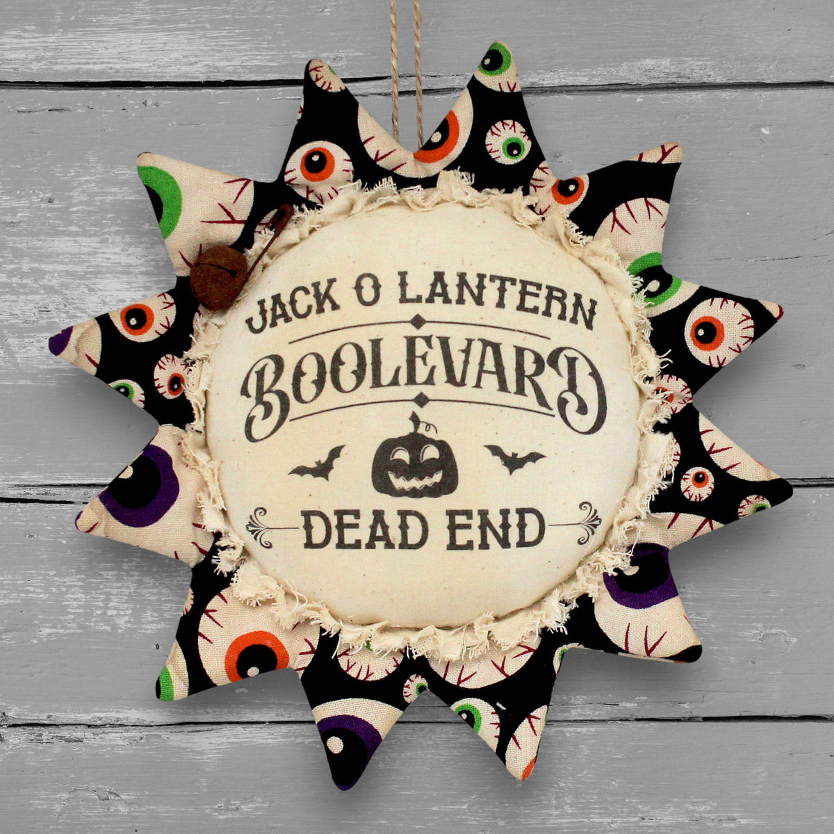 Handmade primitive sunflower ornament with a printed center that reads "Jack O Lantern Boolevard - Dead End"