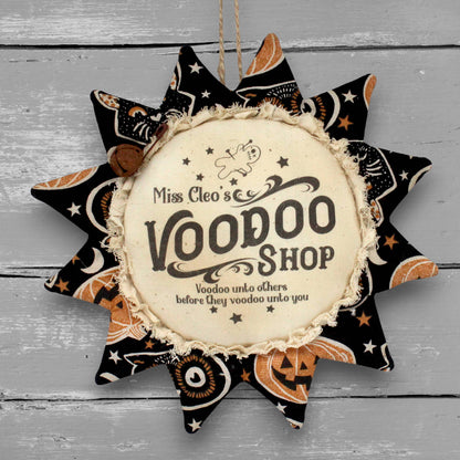 Primitive handmade fabric sunflower for Halloween with a printed center that humorously advertises for a voodoo shop