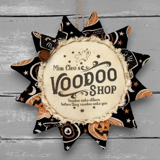 Primitive handmade fabric sunflower for Halloween with a printed center that humorously advertises for a voodoo shop