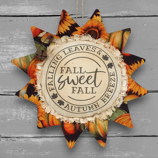 Primitive handmade fabric sunflower with a printed center that reads "Fall Sweet Fall"