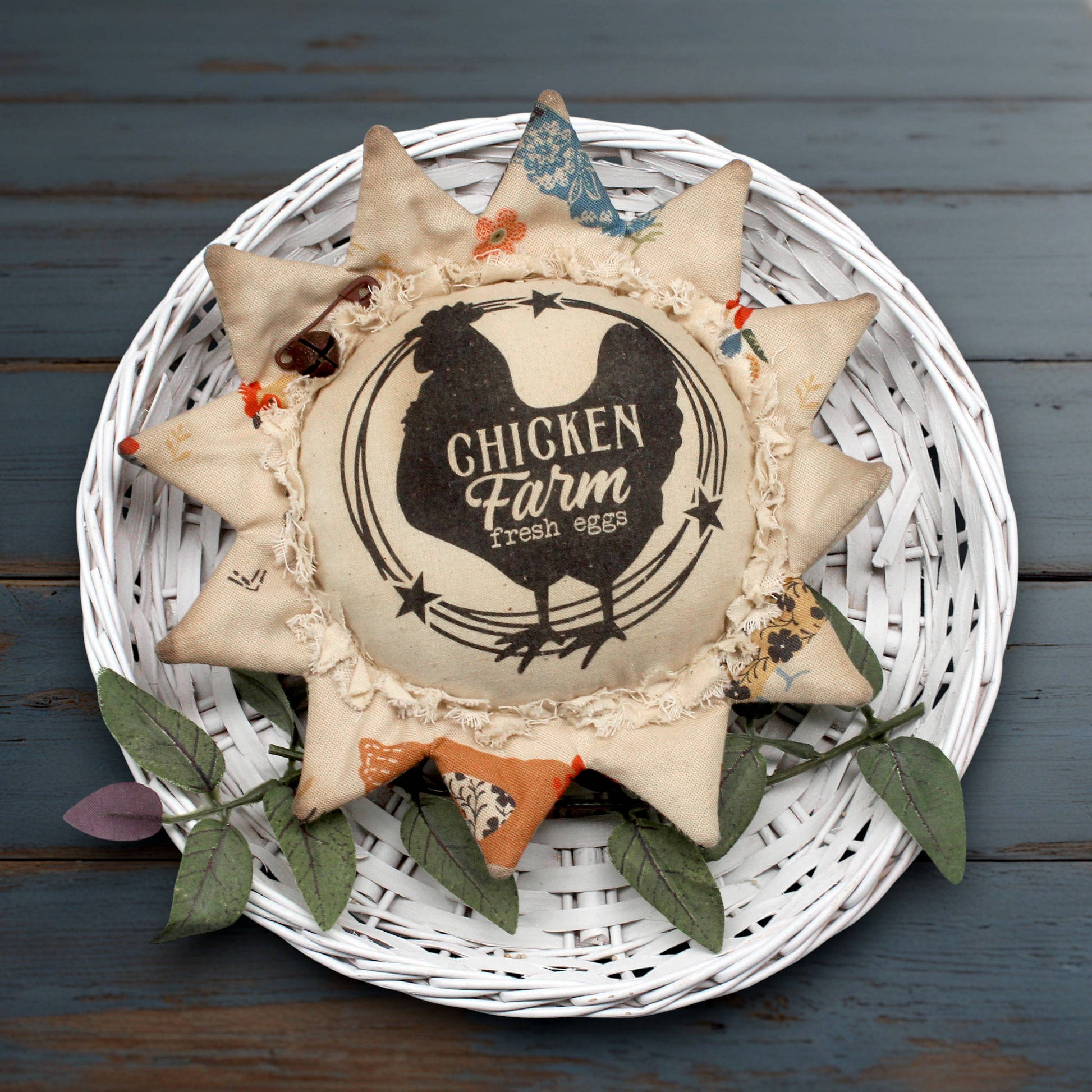 Primitive fabric sunflower ornament with an advertisement for a chicken farm