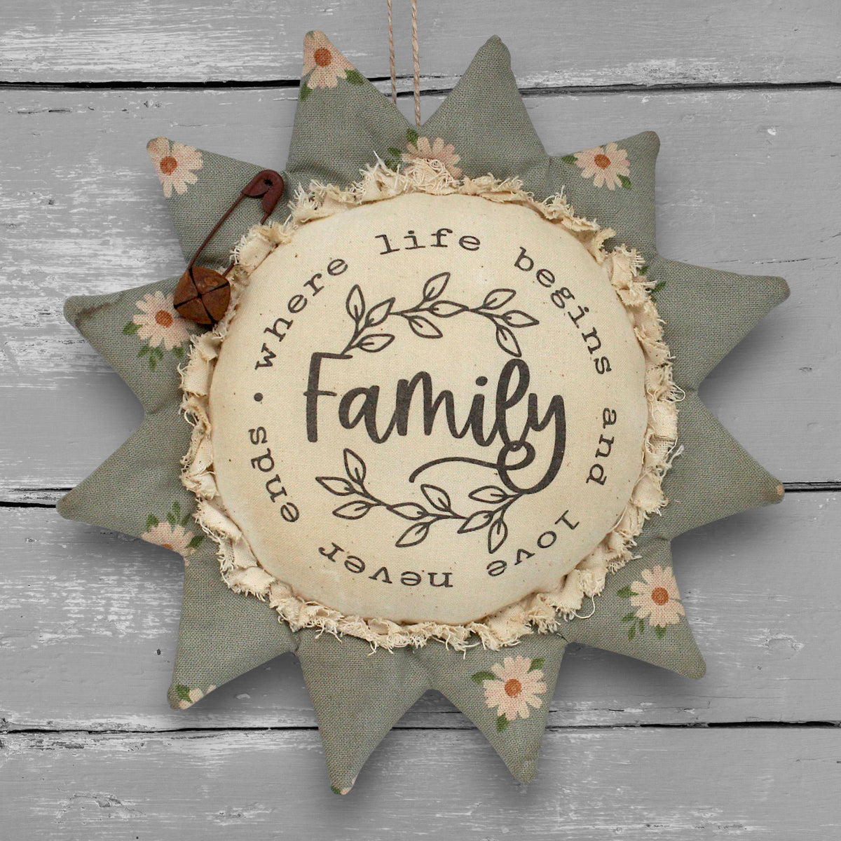 Primitive handmade fabric sunflower ornament with a printed center that reads "Family - where life begins and love never ends."