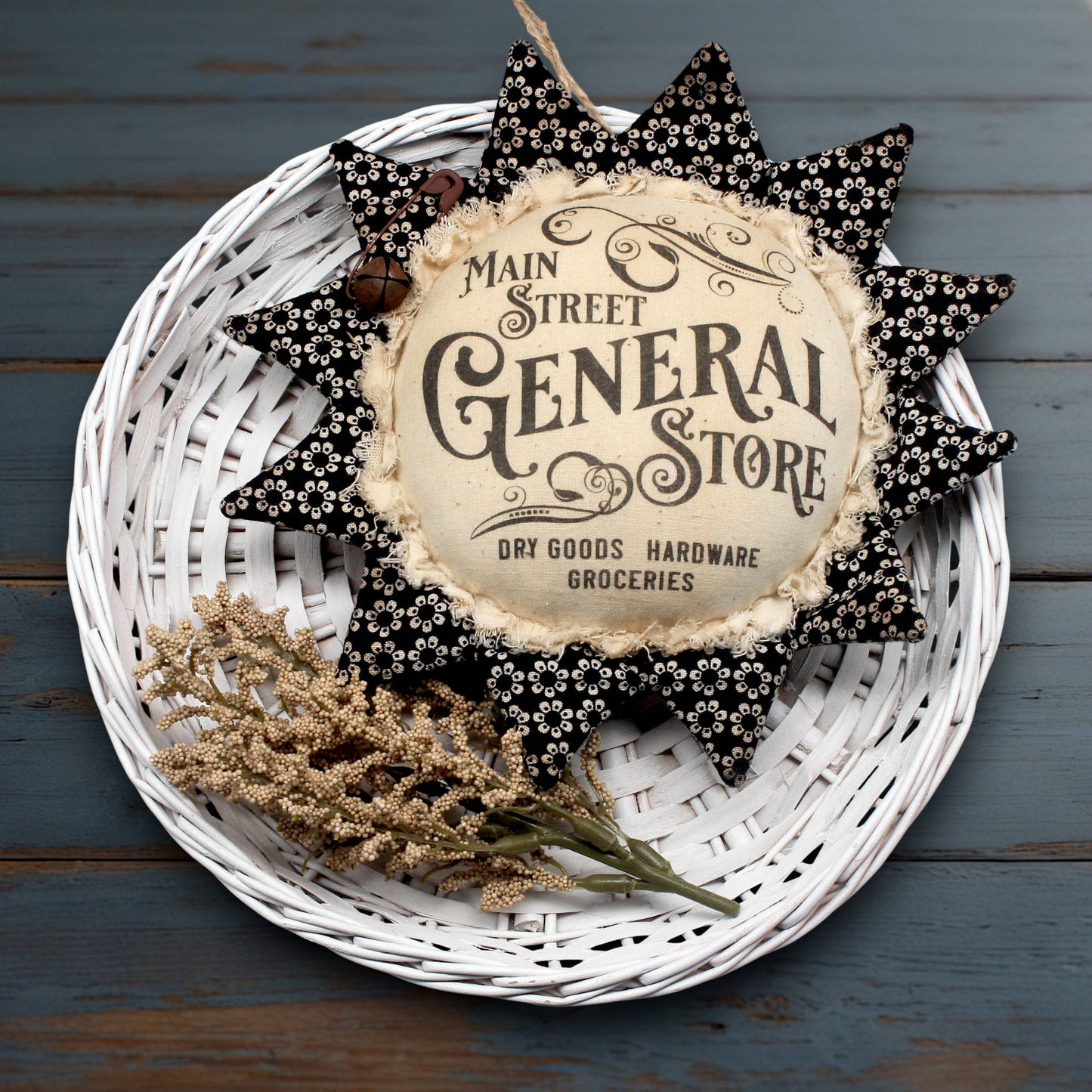 Primitive fabric sunflower ornament with an advertisement for the Main Street General Store