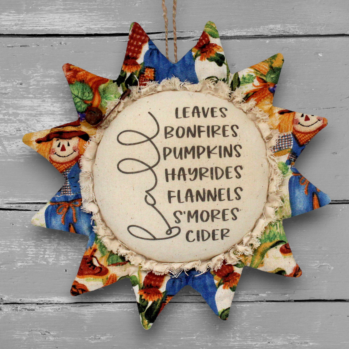 Handmade primitive fabric sunflower ornament with a printed center with a list of favorite things to do in autumn