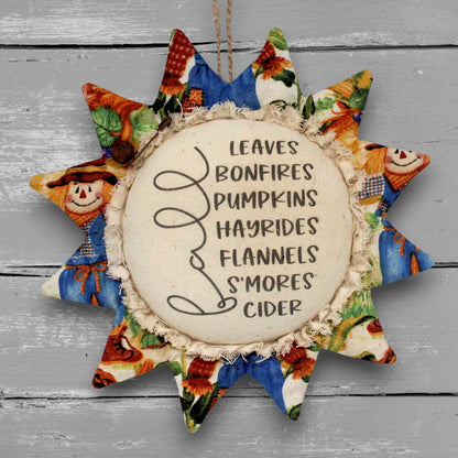 Handmade primitive fabric sunflower ornament with a printed center with a list of favorite things to do in autumn