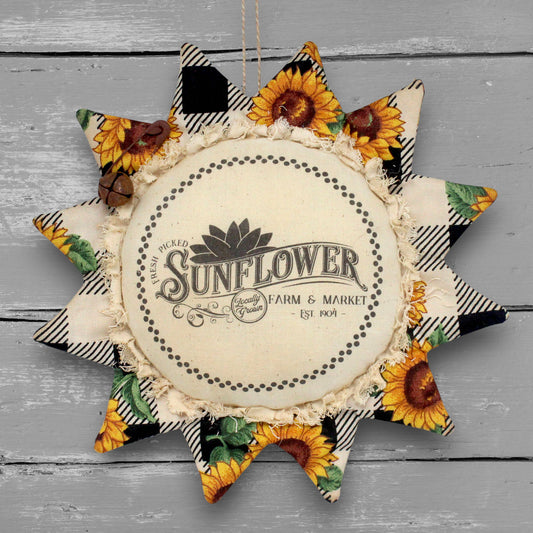 Primitive handmade fabric sunflower ornament with a printed center that advertises for a farm and market