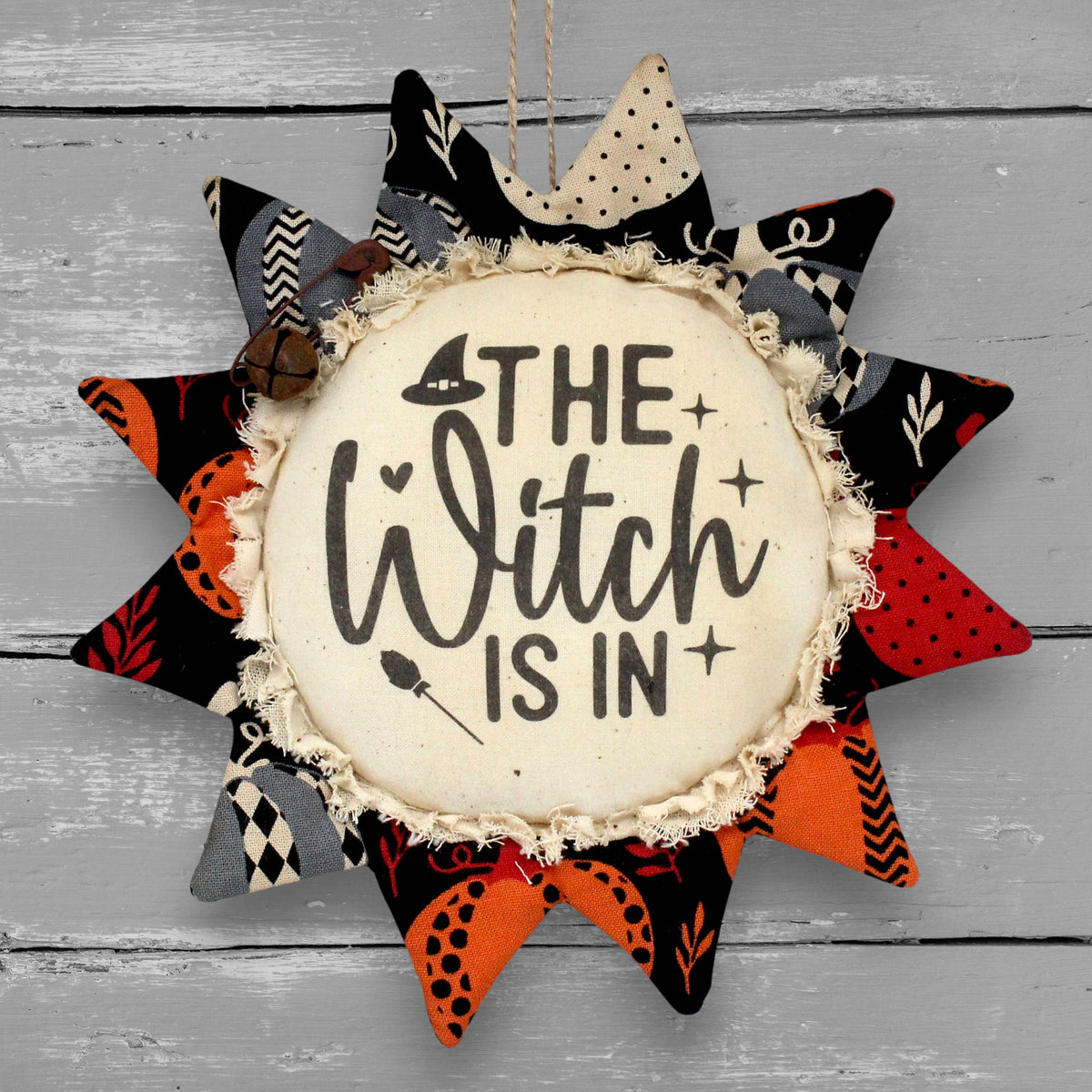 Primitive handmade sunflower ornament that reads "the witch is in"