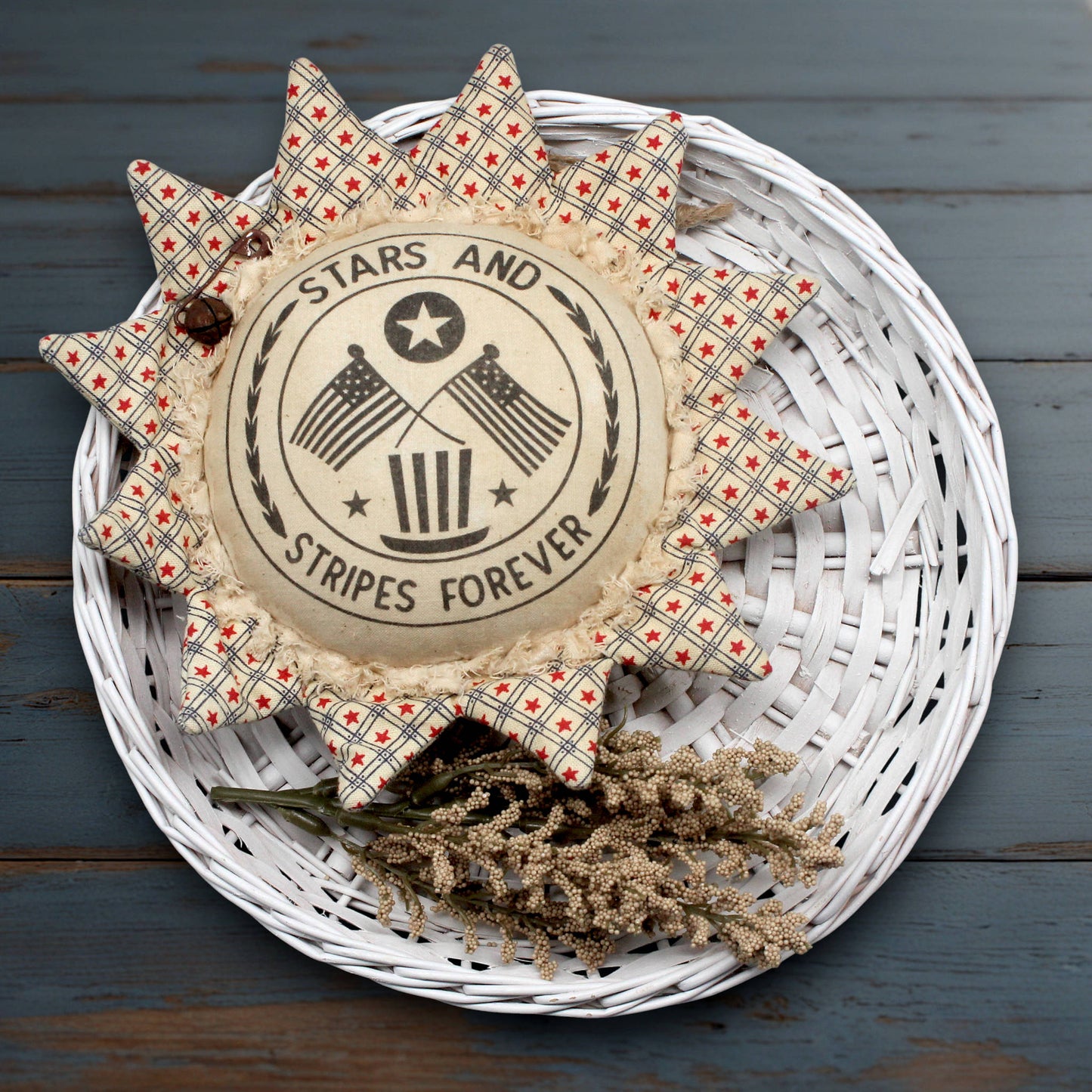 Primitive fabric sunflower ornament with a center printed with 'stars and stripes forever'