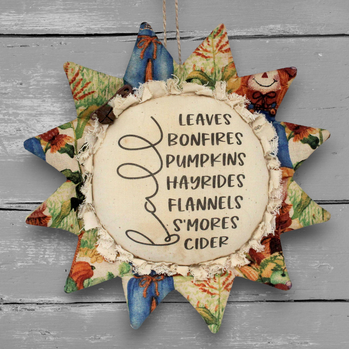 Handmade primitive fabric sunflower ornament with a printed center of a list of favorite fall things