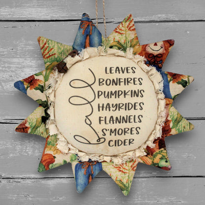 Handmade primitive fabric sunflower ornament with a printed center of a list of favorite fall things