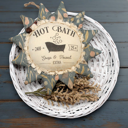 Primitive fabric sunflower ornament with an advertisement for a hot bath
