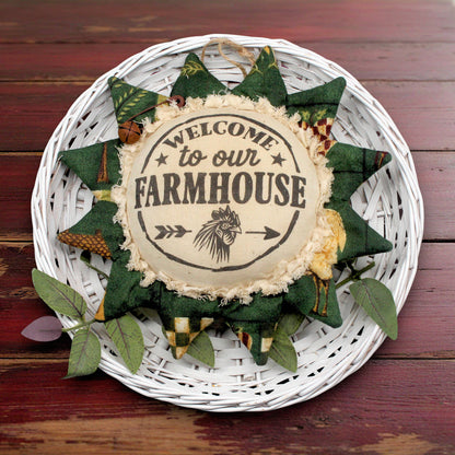 Decorative sunflower ornament with 'Welcome to our Farmhouse' text on a wooden background