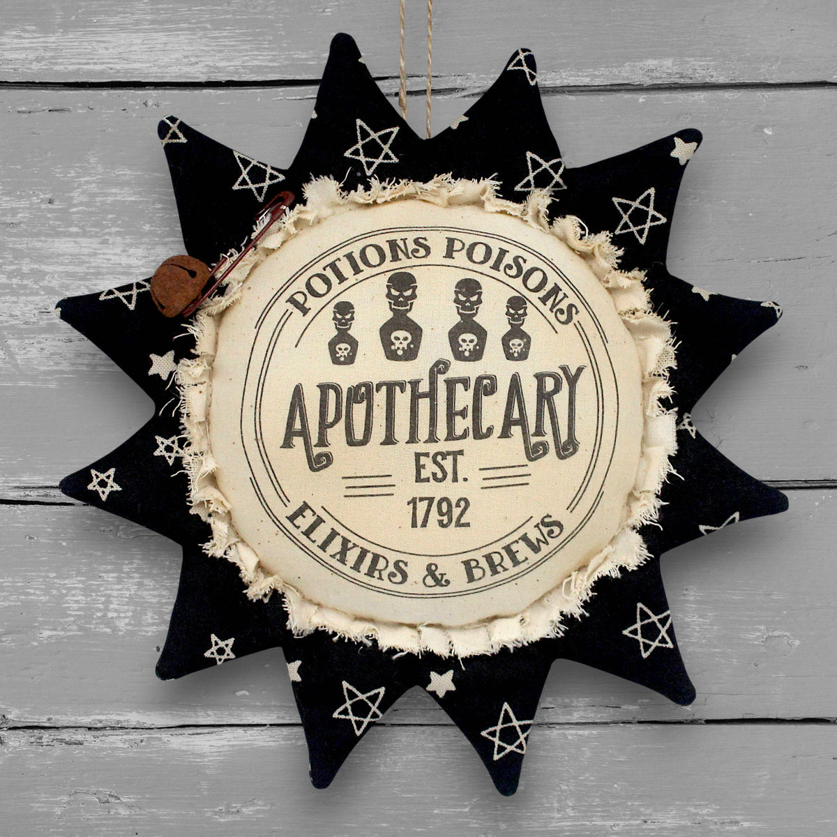 Primitive handmade fabric sunflower ornament with a printed center that advertises for a Halloween apothecary with brews, elixirs and potions.