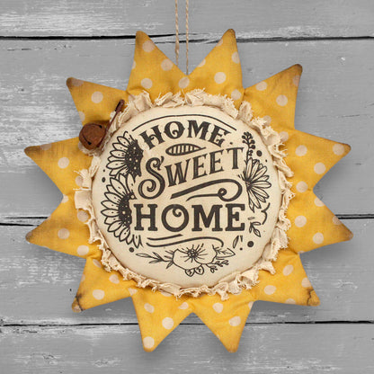 Primitive handmade fabric sunflower ornament with a printed center that reads "Home Sweet Home"
