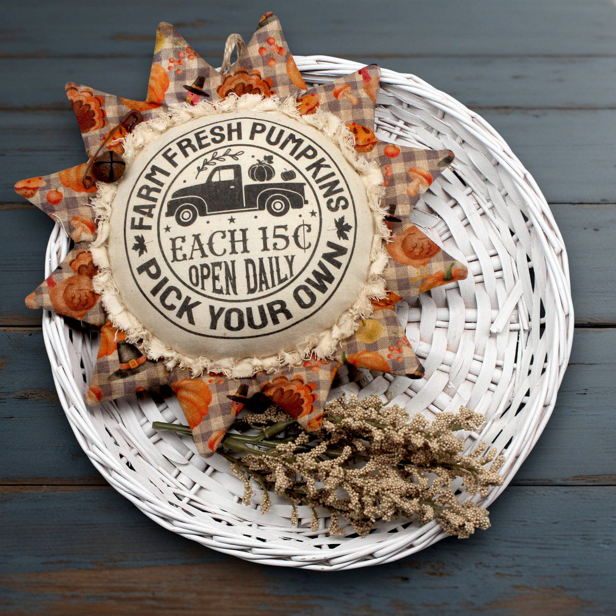 Primitive fabric sunflower ornament with an advertisement for farm fresh pumpkins