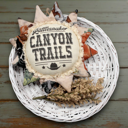 Western style fabric sunflower ornament with an advertisement for Canyon Trails