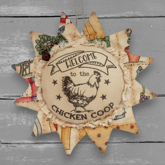 Handmade primitive fabric sunflower ornament with a printed center that reads 'welcome to the chicken coop'