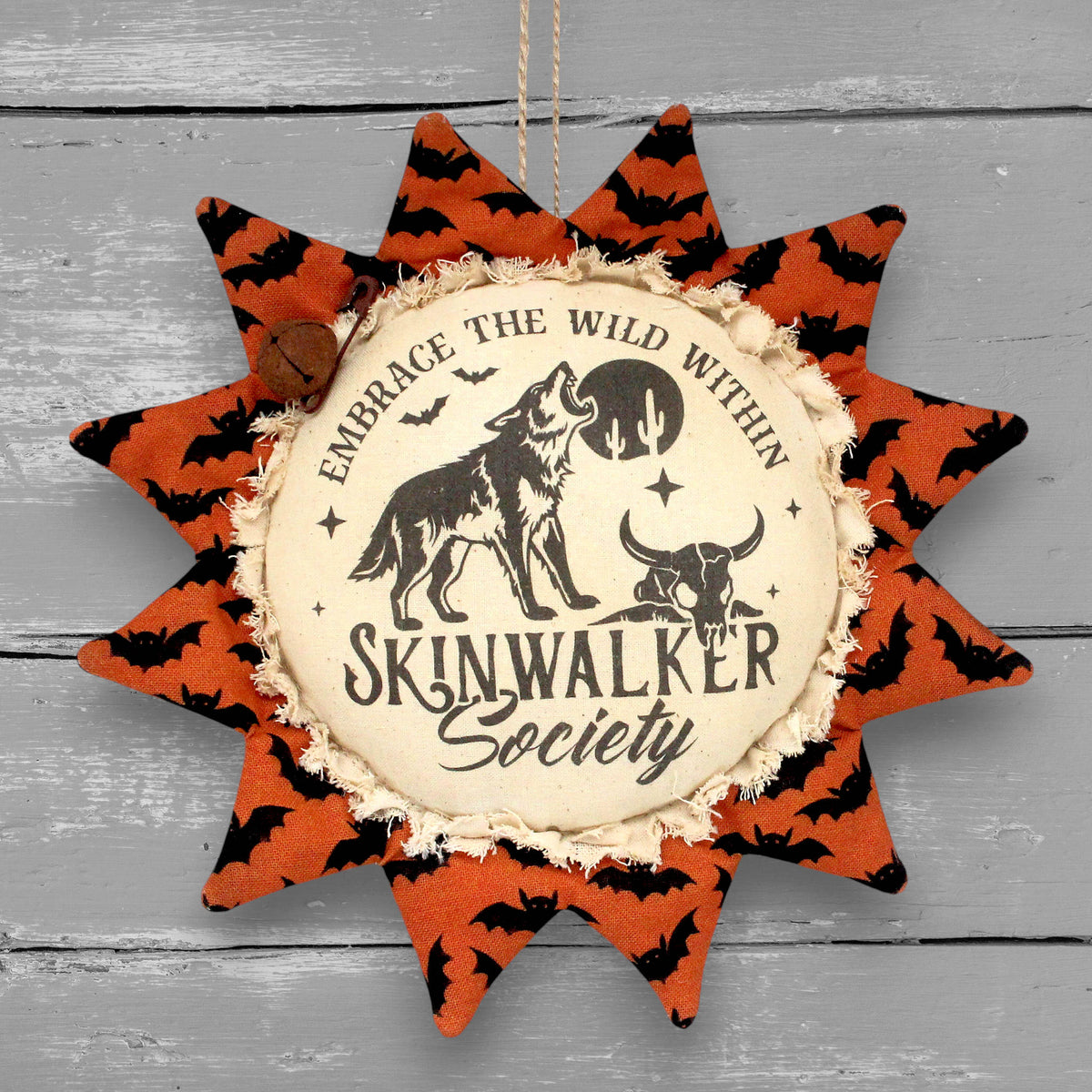Primitive handmade Halloween sunflower ornament with a printed center that advertises for the Skinwalker Society.