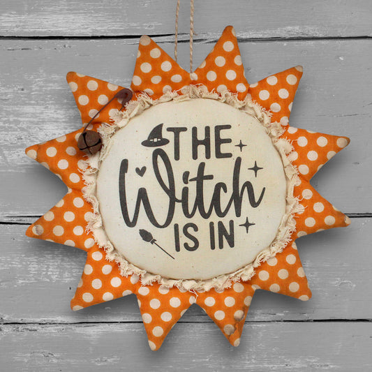 Primitive handmade fabric sunflower ornament or bowl filler for Halloween with a printed center that reads "The witch is in."