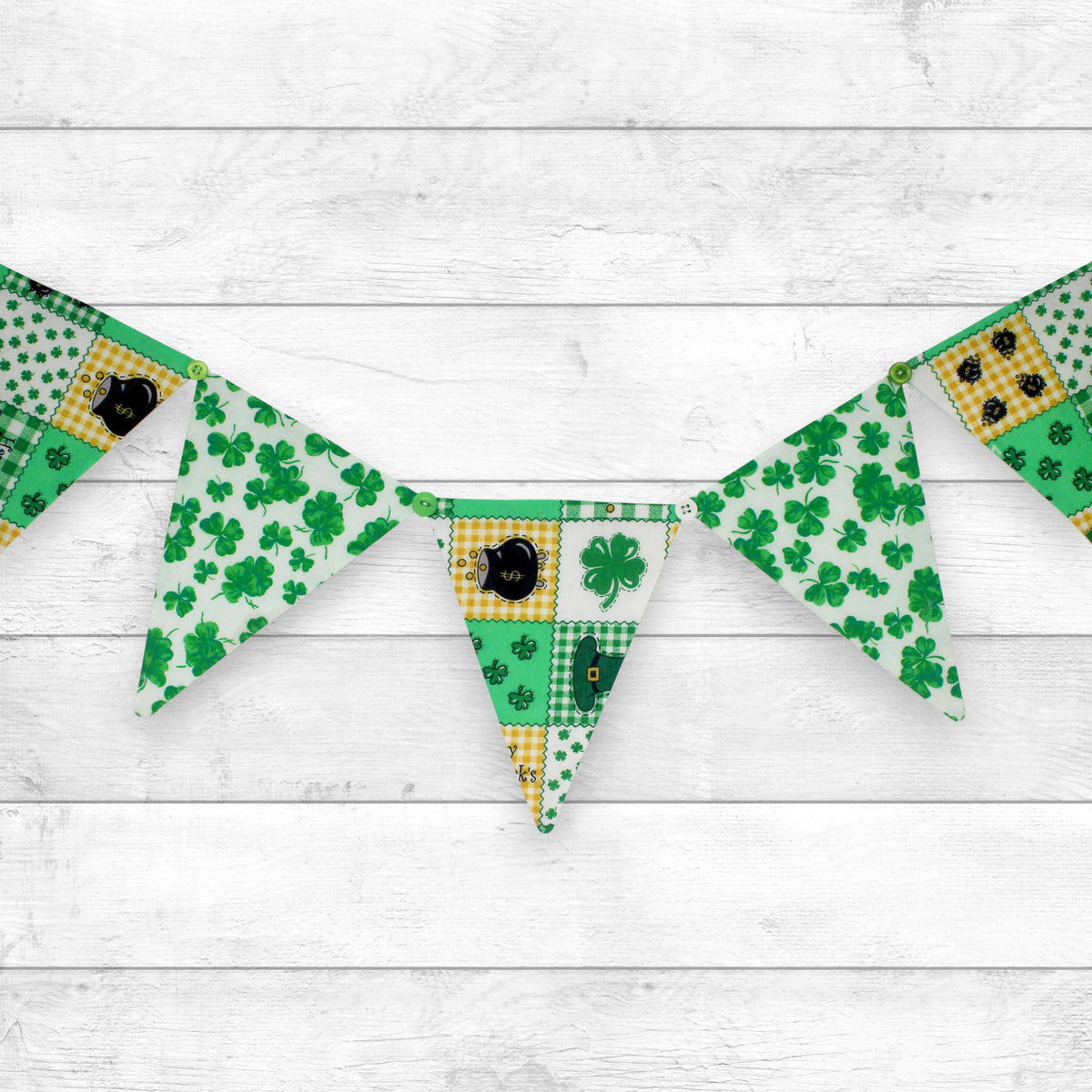 a fabric bunting banner made with alternating saint patrick's day print fabrics